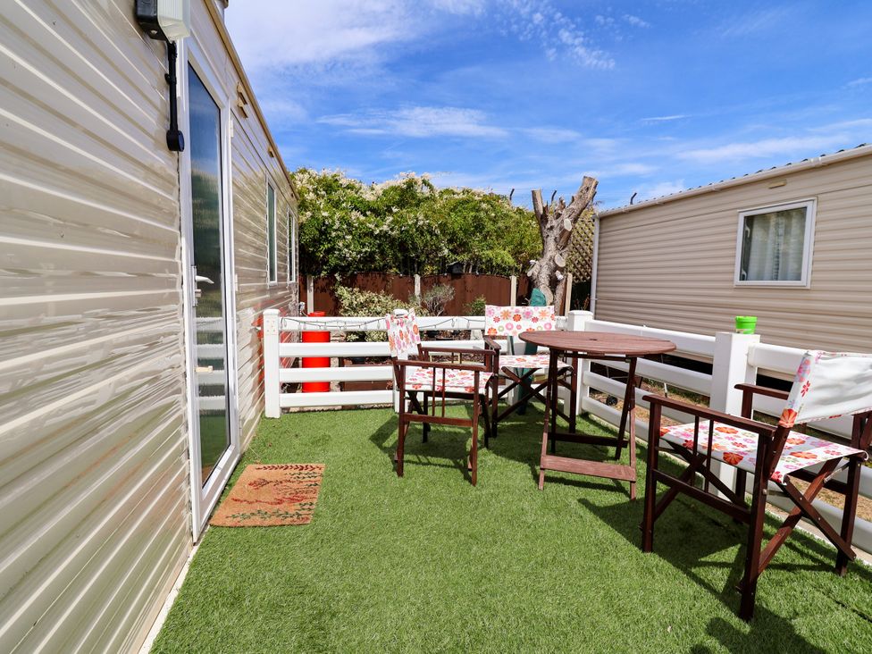 A patio with table and chairs at Plot 594 Prestatyn
