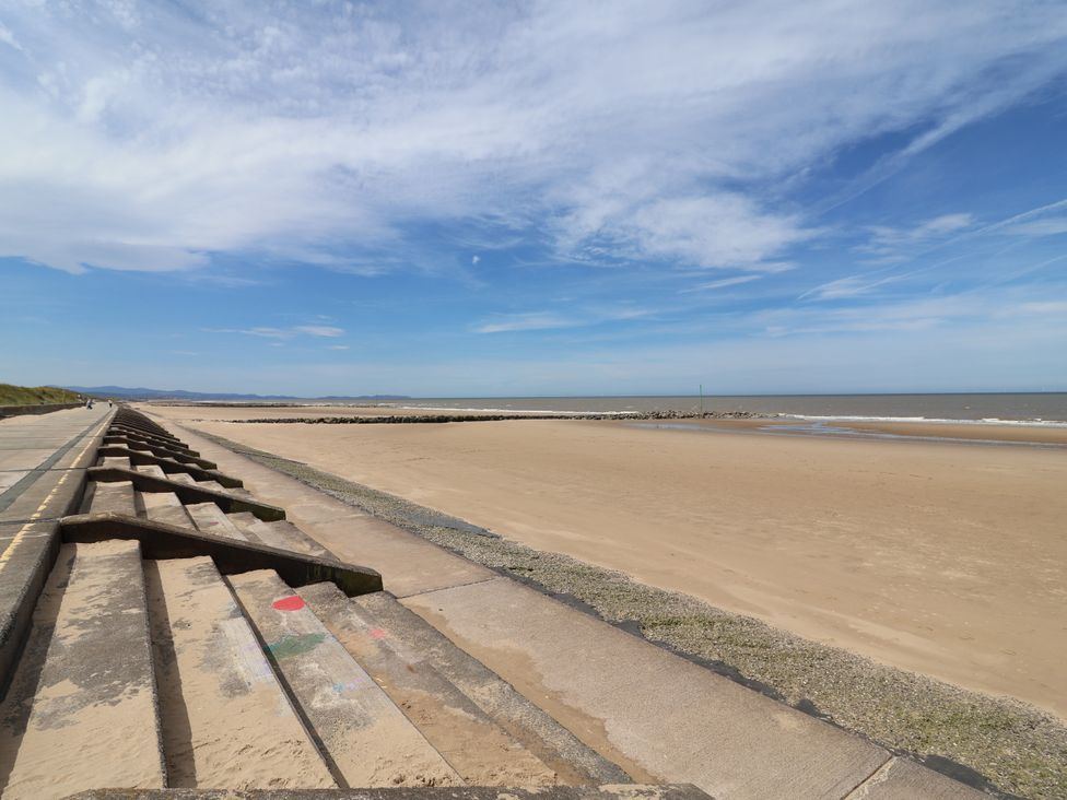 A beach with steps leading down to the sand at Plot 594 in Prestatyn