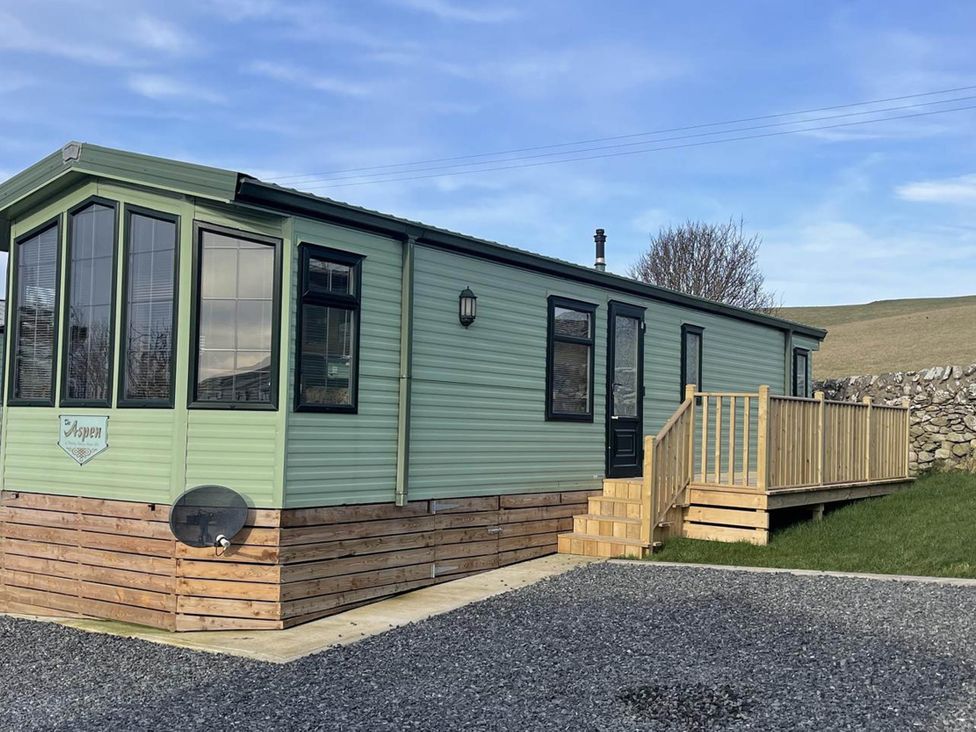 A static caravan with a deck and steps at Immaculate 2-Bed Static Caravan at Monrieth near Whithorn