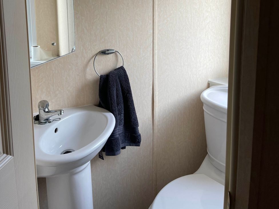 A bathroom with a sink and toilet at Immaculate 2-Bed Static Caravan at Monreith near Whithorn