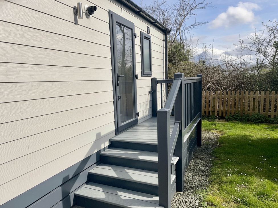 An entrance with a staircase leading to a door at Chalet 4 guests Parking Available near Tuxford
