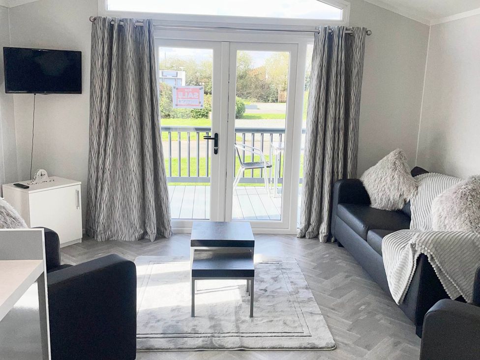 A living room with a sofa and television at Chalet 4 guests Parking Available near Tuxford