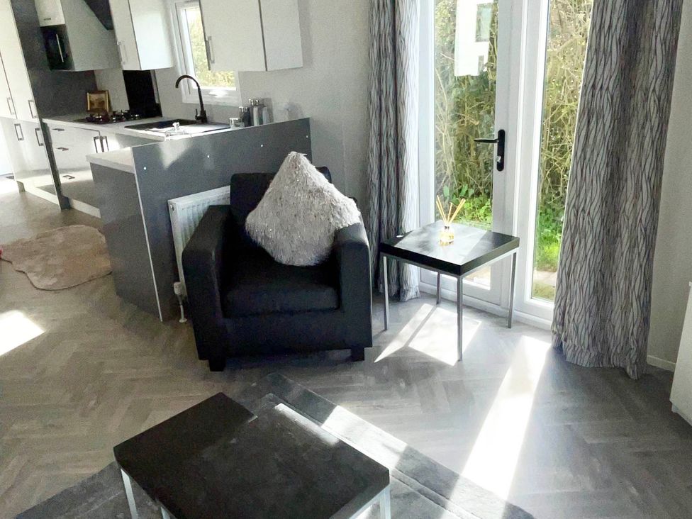 A living room with a sofa and a coffee table at Chalet 4 guests Parking Available near Tuxford