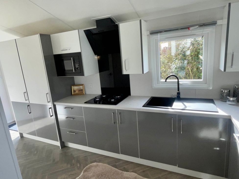 A kitchen with cabinets and a sink at Chalet 4 guests Parking Available near Tuxford