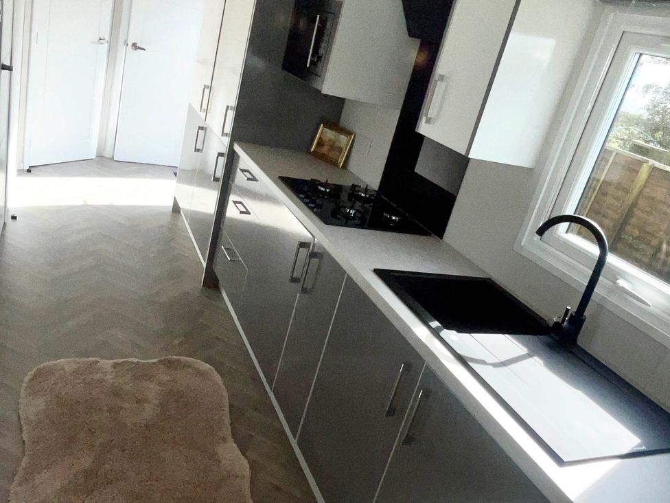 A kitchen with cabinets and a gas stove at Chalet 4 guests Parking Available near Tuxford