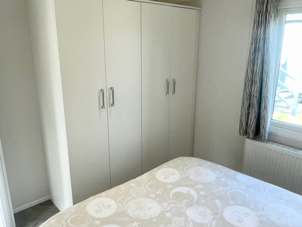 A bedroom with a wardrobe and bed at Chalet 4 guests Parking Available near Tuxford