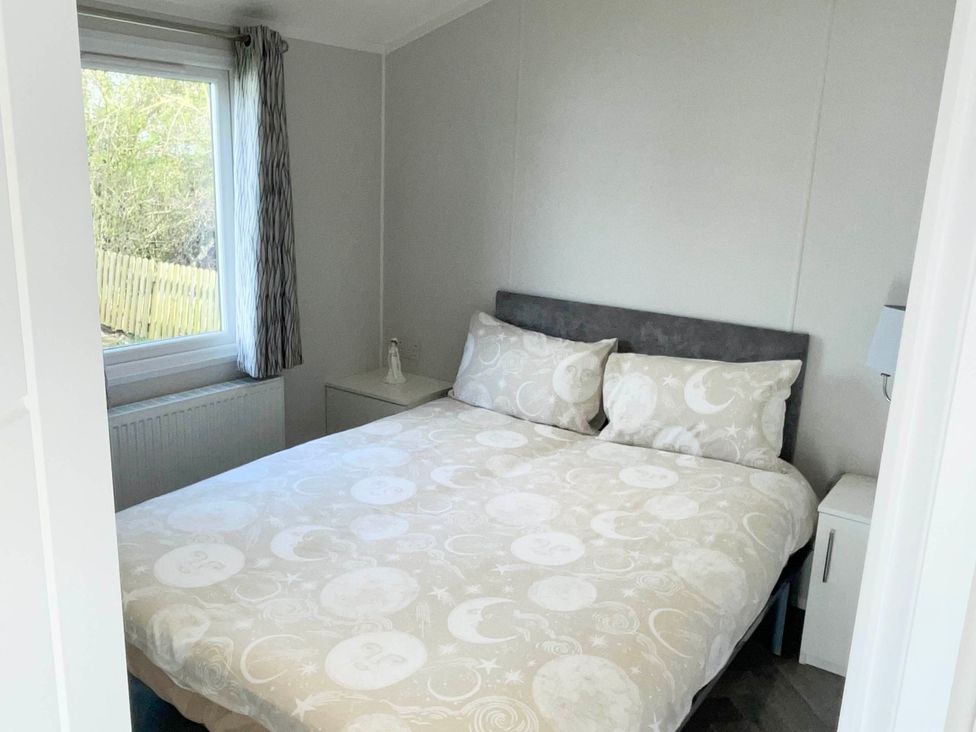 A bedroom with a bed and bedside table at Chalet 4 guests Parking Available near Tuxford