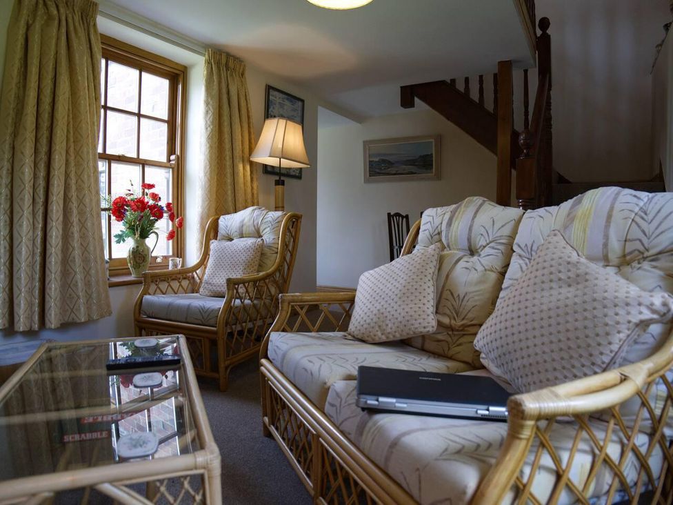 A living room with a sofa and table at Cottage Sleeps 2 Garden Parking in Ryton