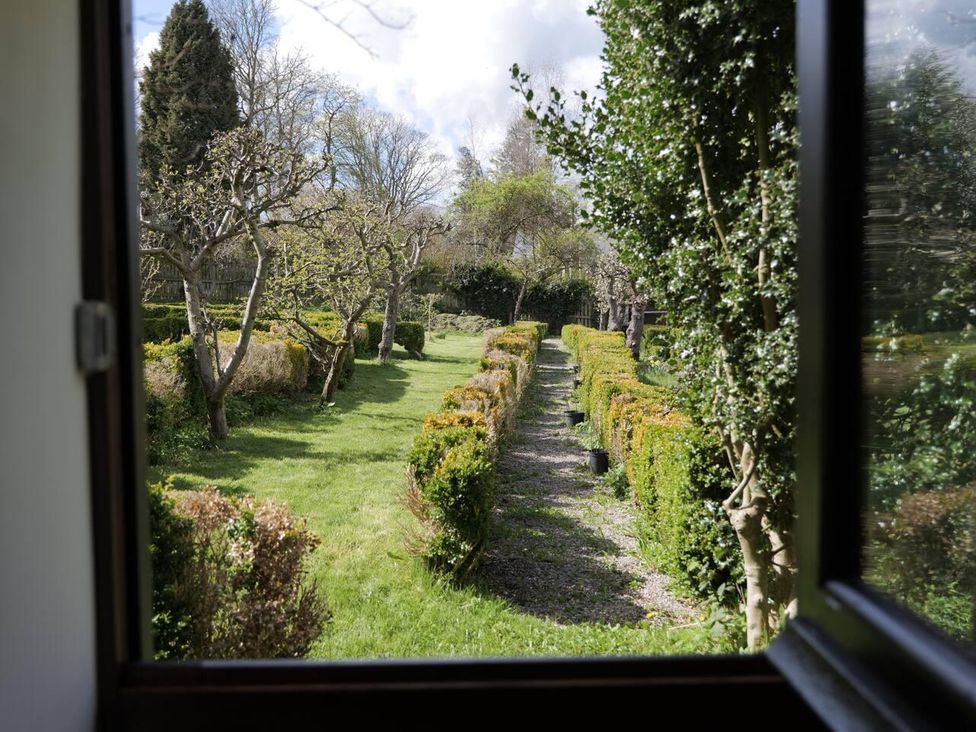 A garden view with trees and a path at Cottage Sleeps 2  Garden Parking in Ryton