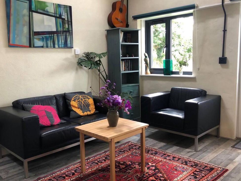 A living room with a sofa and armchair at Little Linney Sleeps 2 Garden  Parking  Wifi in Hartland