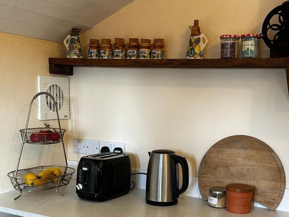 A kitchen countertop with a kettle and toaster at Little Linney Sleeps 2 Garden Parking Wifi in Hartland