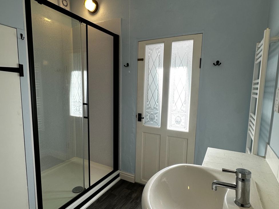 A bathroom with a shower and sink at Little Linney Sleeps 2 Garden Parking Wifi Hartland