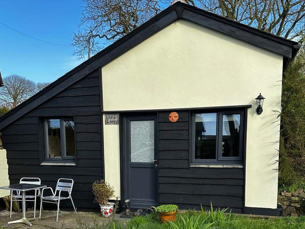 A small house with a door and windows at Little Linney in Hartland