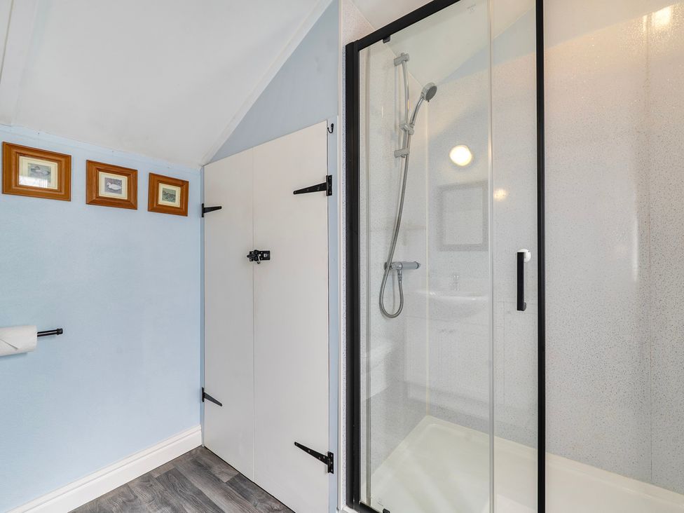 A bathroom with a shower and sink at Little Linney Sleeps 2 Garden Parking Wifi in Hartland
