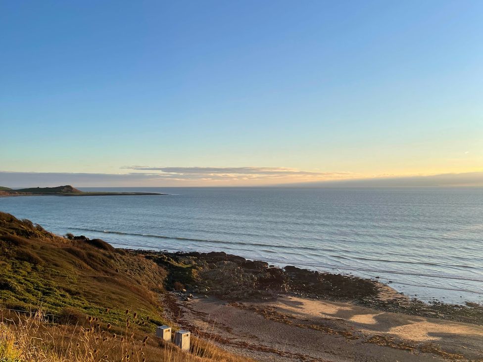 A beach view with ocean and rocks at Beautiful 2 Bed Static caravan