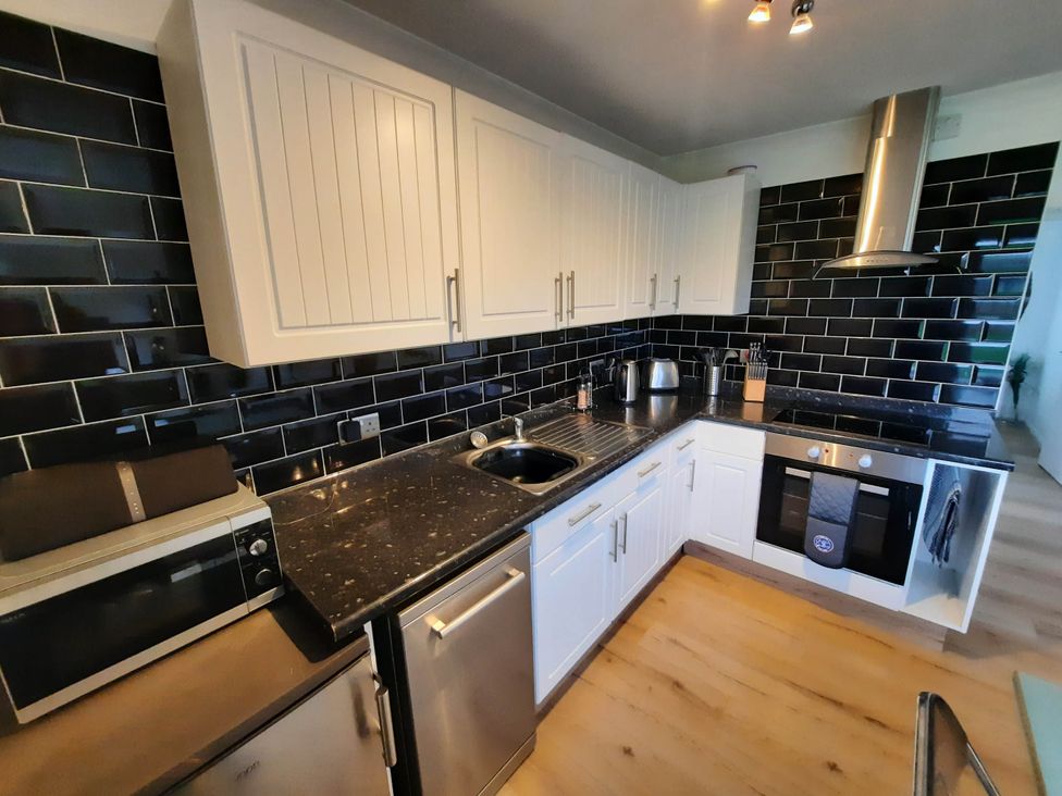 A kitchen with cabinets, sink, microwave, and stove at St Margaret's 2 Bed Chalet Sleeps 4 Pets Ok