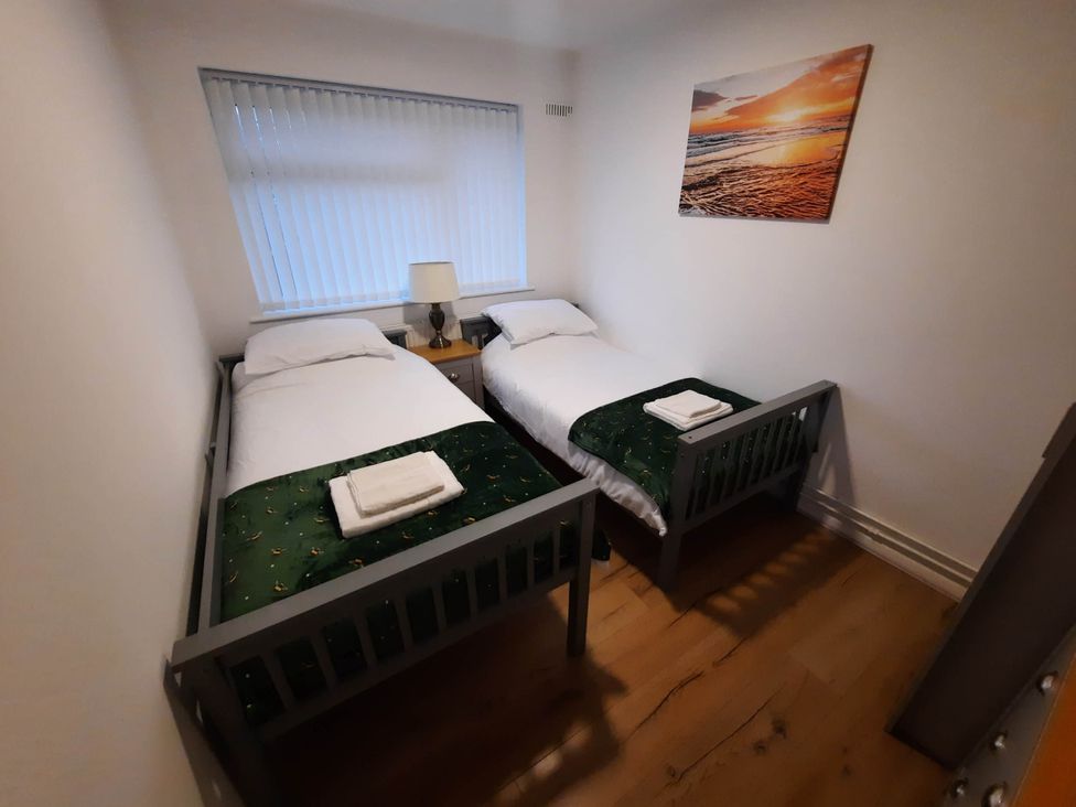 A bedroom with two single beds and a lamp at St Margaret's 2 Bed Chalet Sleeps 4 Pets Ok