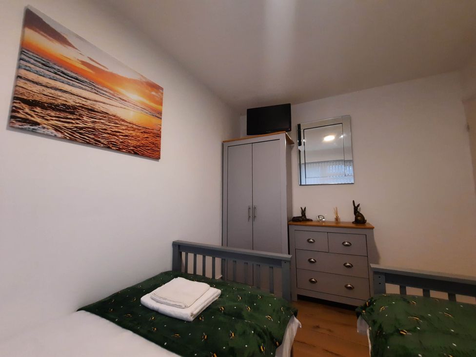 A bedroom with two beds and a wardrobe at St Margaret's 2 Bed Chalet Sleeps 4 Pets Ok