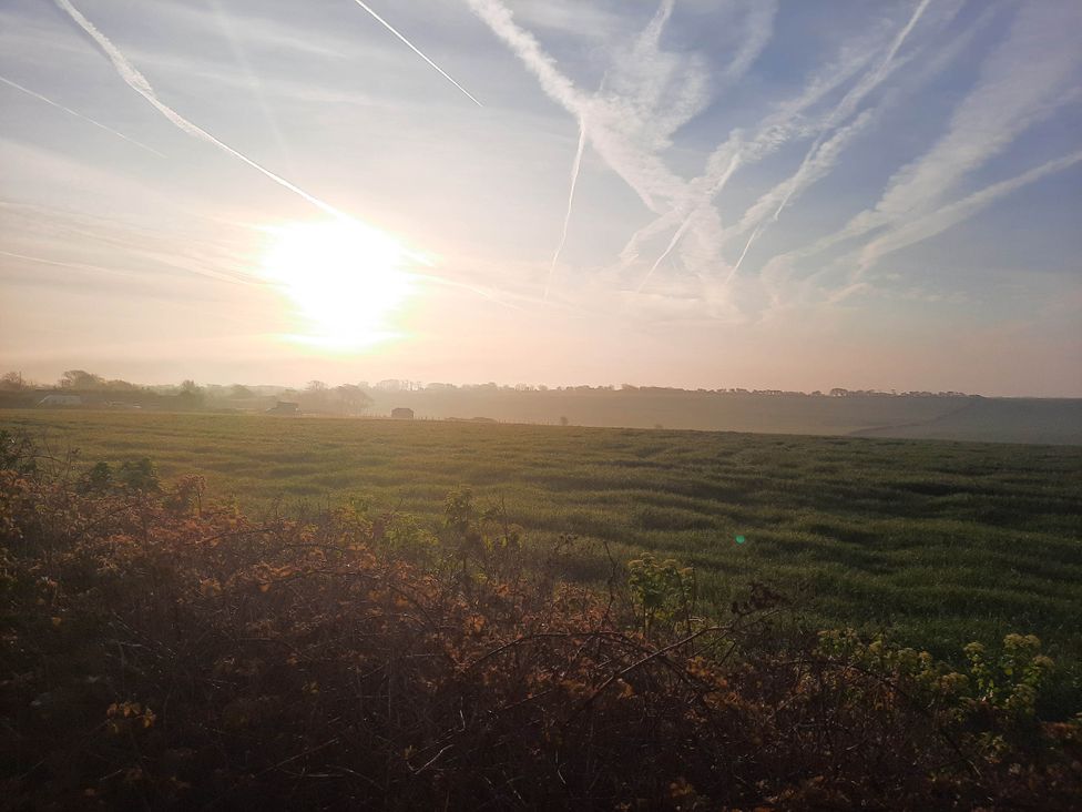 A field with a sunset and clouds at St Margaret's 2 Bed Chalet Sleeps 4 Pets Ok