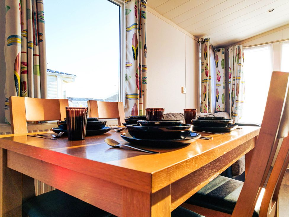 A dining room with a table set for meals at Captivating 6-Person Caravan in Rhyl