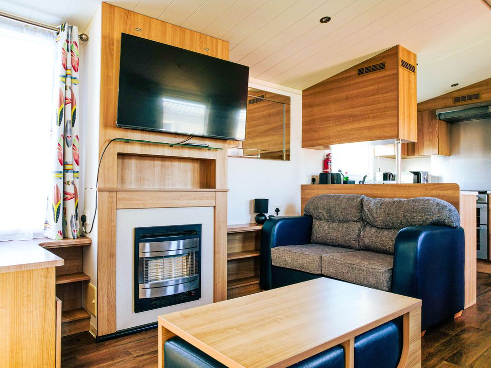 A living room with a television and sofa at Captivating 6-Person Caravan in Rhyl