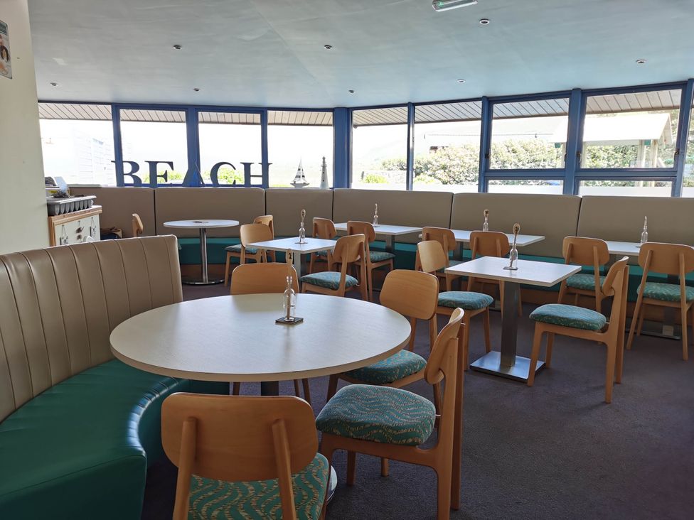 A dining room with tables and chairs at Sea and Mountain view Sunbeach Holiday Snowdonia