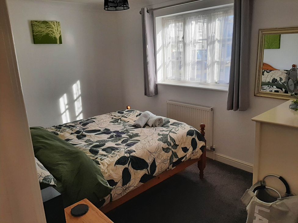 A bedroom with a bed and mirror at Ground Floor Cornish Retreat Free Parking in Bodmin