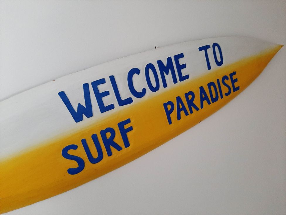 A surfboard with welcome sign at Ground Floor Cornish Retreat Free Parking Bodmin