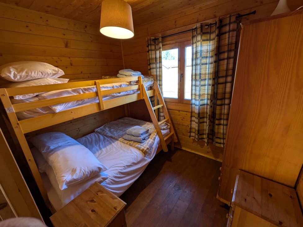 A bedroom with bunk bed and double bed at Pet Friendly - Lodge at Riverview Holiday Park, Mangerton near Newcastleton