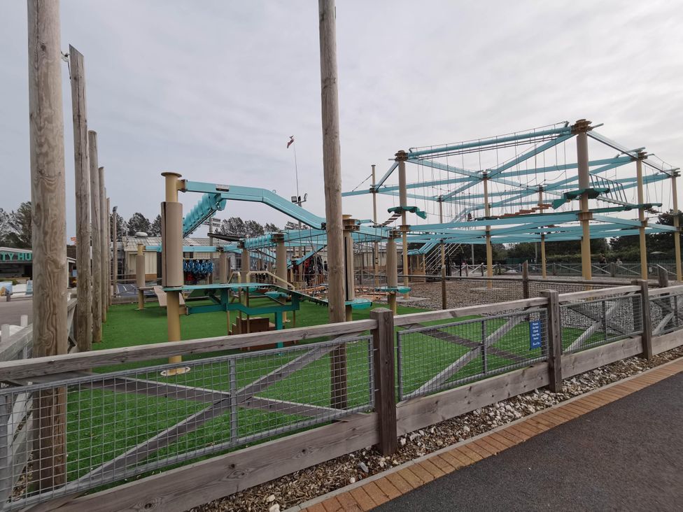 An outdoor play area with climbing structures and safety barriers at 8Berth- SmartTV- CloseToBeach- FamilyFriendly in Mablethorpe