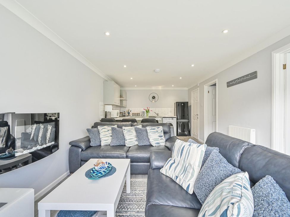 A living room with a grey sofa and coffee table at 8Berth- SmartTV- CloseToBeach- FamilyFriendly, Millendreath near Looe