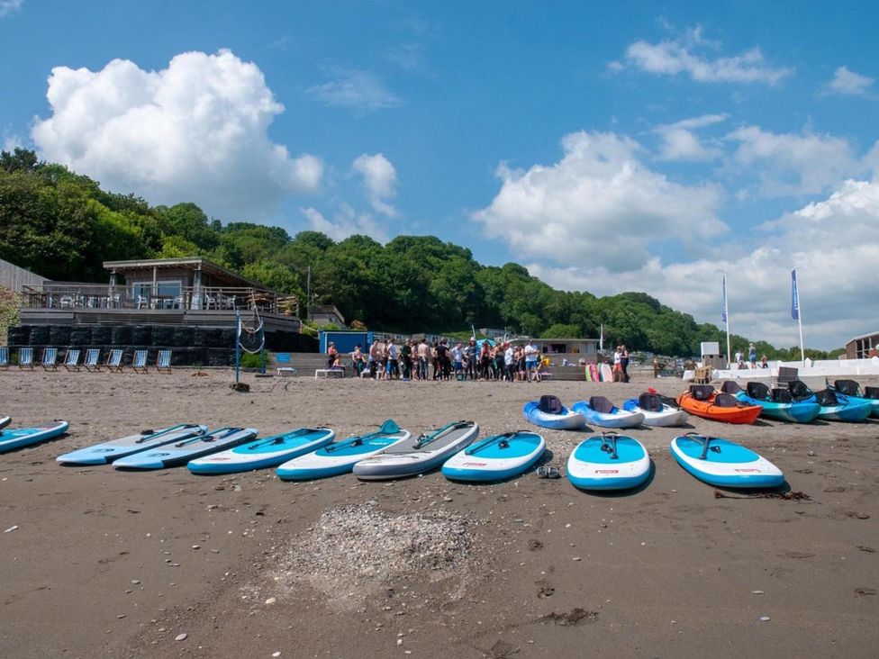 Paddleboards on a beach with people in the background at 8Berth- SmartTV- CloseToBeach- FamilyFriendly, Millendreath near Looe