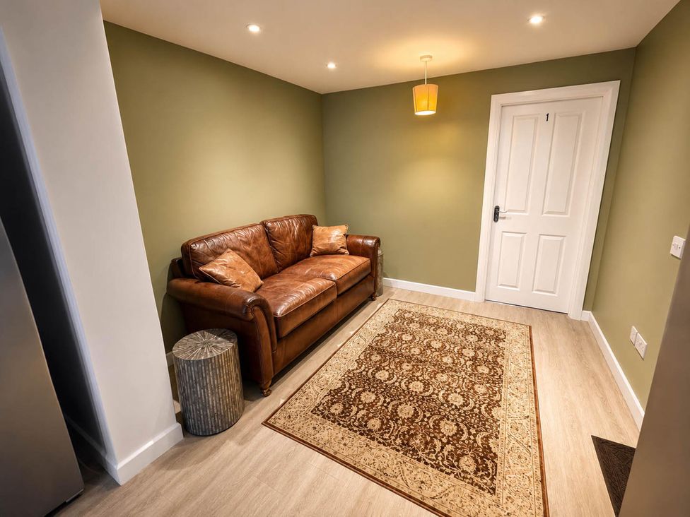 A living room with sofa and rug at House Sleeps 12 with WiFi in Bristol