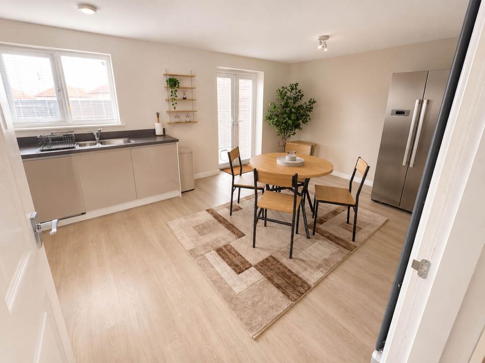 A dining room with a table and four chairs at House Sleeps 12 with WiFi in Bristol