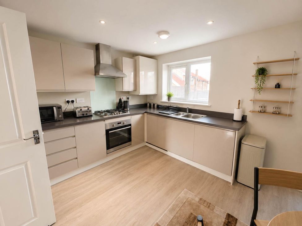 A kitchen with stove, sink, and microwave at House Sleeps 12 with WiFi in Bristol