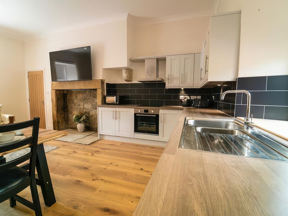 A kitchen with countertop, sink, oven, and microwave at Foundry Farm Apartment