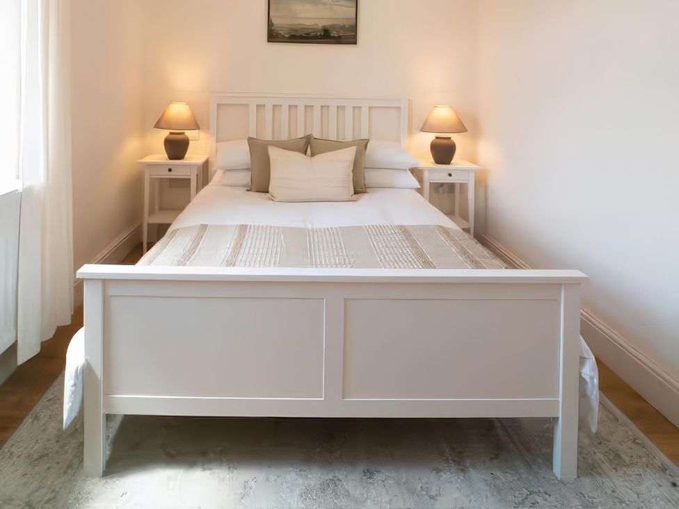 A bedroom with a bed and nightstands at Foundry Farm Apartment