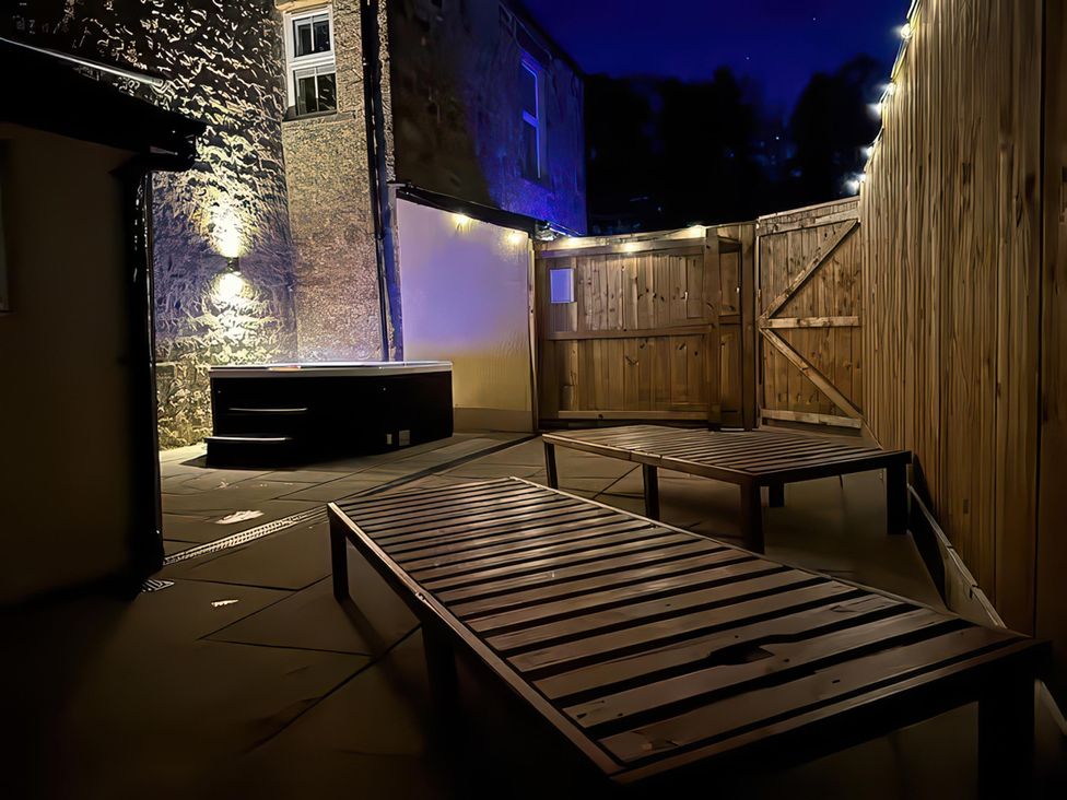 An outdoor area with a hot tub and deck chairs at Foundry Farm Apartment