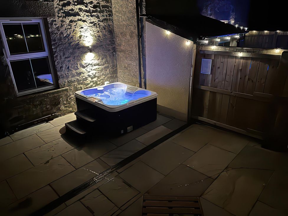 An outdoor area with a hot tub at Foundry Farm Apartment