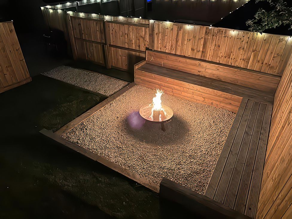 An outdoor seating area with a fire pit and gravel at Foundry Farm Apartment