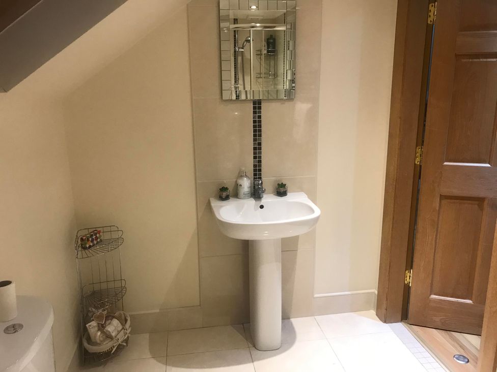 A bathroom with a sink and mirror at Dungannon 2 Bed Bungalow - Sleeps 5 - Pet Friendly near Dungannon