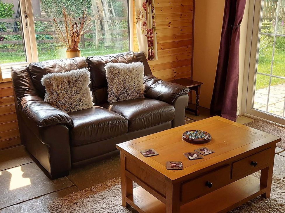 A living room with a sofa and coffee table at 1 Bed Lodge-Sleeps 4-Pet Friendly-Free Parking near Hay-On-Wye