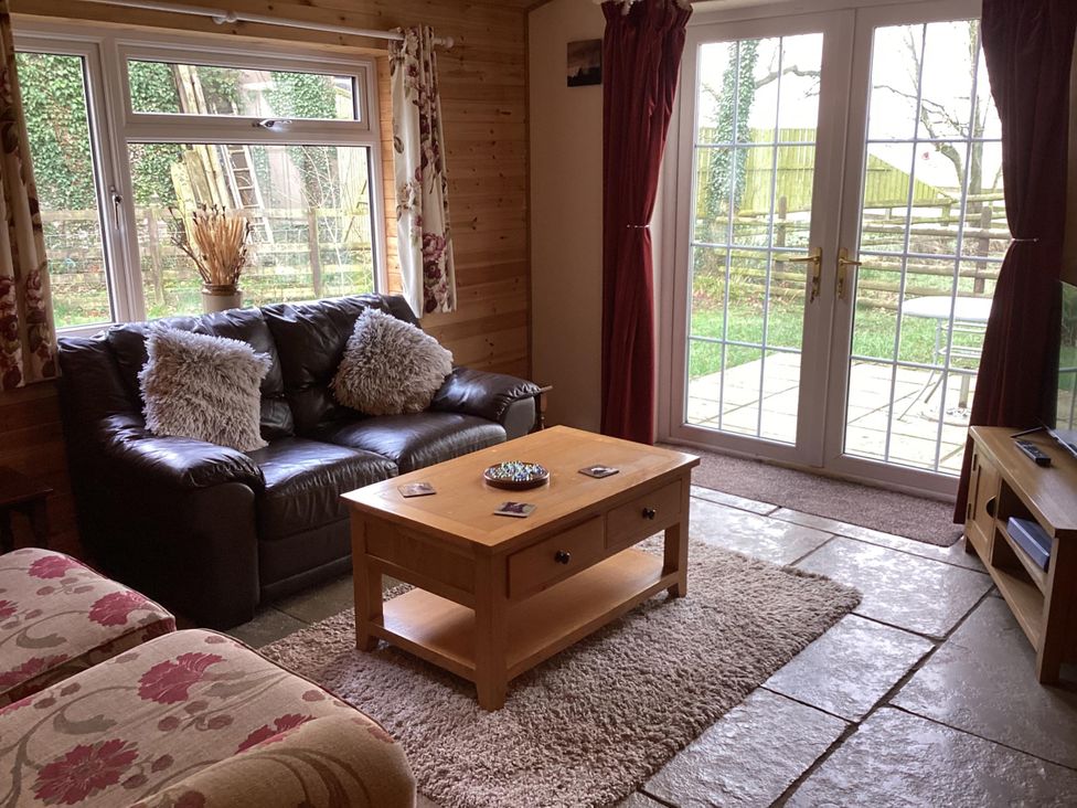 A living room with a sofa and coffee table at 1 Bed Lodge-Sleeps 4-Pet Friendly-Free Parking near Hay-On-Wye