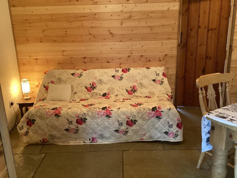 A living room with a sofa and table at 1 Bed Lodge-Sleeps 4-Pet Friendly-Free Parking near Hay-On-Wye