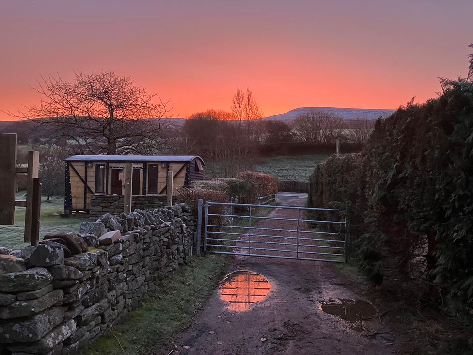 A pathway with a gate and a wheeled structure at Transformed Railway Wagon- Sleeps2-Garden-Firepit in Powys near Crickhowell