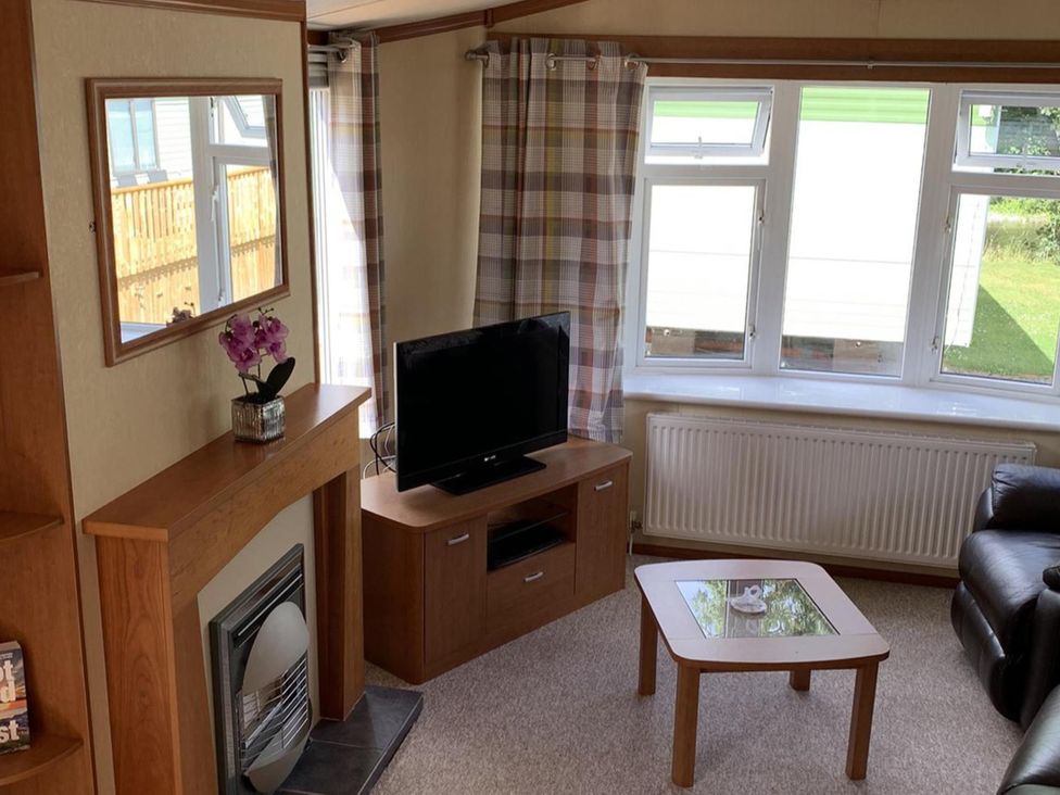A living room with a television and fireplace at Static Caravan 2 Bedrooms - sleeps 4 Hawick