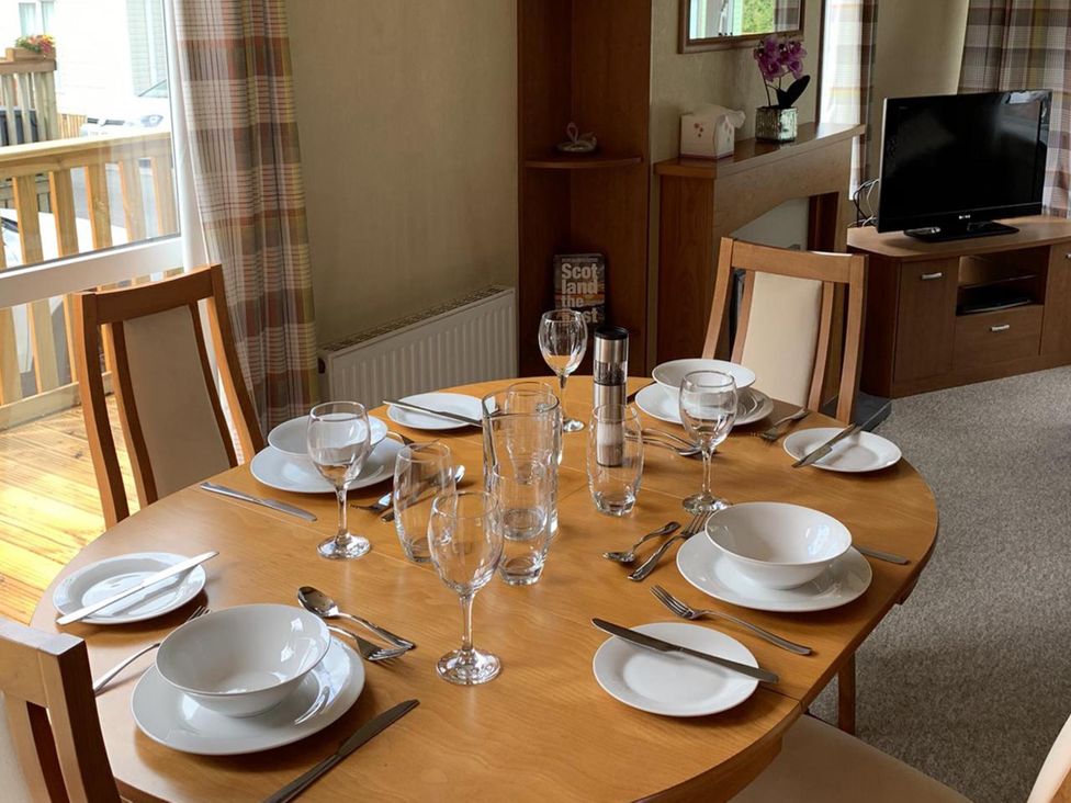 A dining room with a table set for meals at Static Caravan 2 Bedrooms - sleeps 4, Hawick