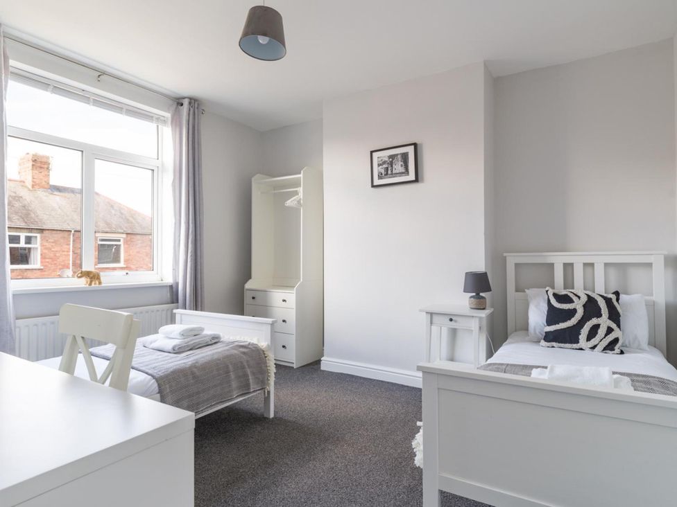 A bedroom with two beds and a wardrobe at Lily Apartment - Sleeps 3 - Pet friendly - Parking in Bedlington