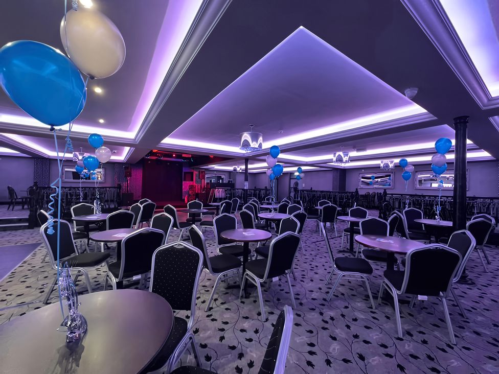 An event hall with tables and chairs decorated with balloons at 3 Bed, Sleeps 6, Parking