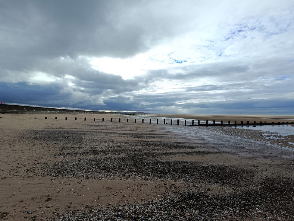 A beach with sand and poles at an unspecified location